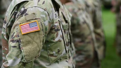Detail clip with american flag on soldier uniform standing in military position during ceremony - Powered by Adobe