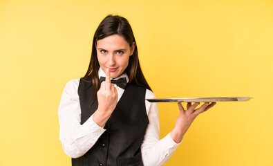 young adult pretty woman feeling angry, annoyed, rebellious and aggressive. waiter and tray concept
