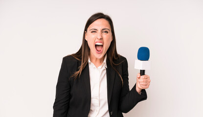 young adult pretty woman shouting aggressively, looking very angry. presenter with a microphone...