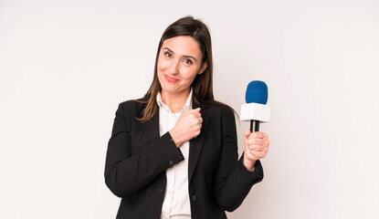 young adult pretty woman feeling happy and facing a challenge or celebrating. presenter with a...