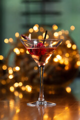 glass with alcoholic drink. against the backdrop of lights.