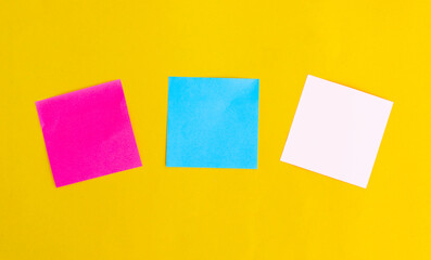 three color blank note paper on Yellow paper background