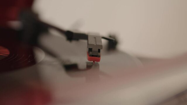 Old phonograph  being played in a cozy room. a vinyl needle turntable retro cd. macro shot MXF