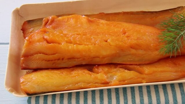 smoked haddock fillet in a tray with dill