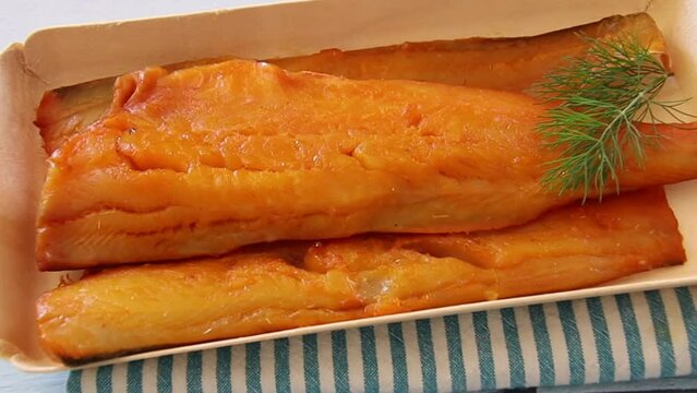 smoked haddock fillet in a tray with dill