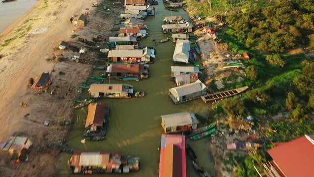 The traditional houses of Chong Kneas Floating Village towards Tonle Sap Lake in Asia, Cambodia, towards Siem Reap, in summer on a sunny day.