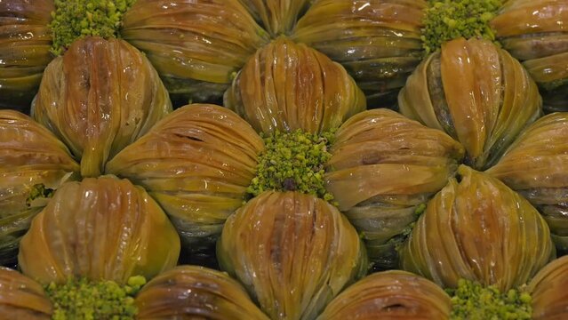 Traditional delicious Turkish midye baklava with green pistachio nuts