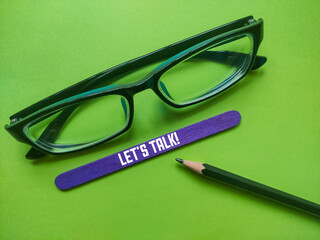 Ice cream sticks with Let's Talk writing on a green background.