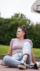 girl sitting on basketball court