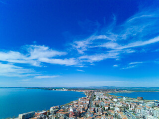 Panoramic view from a height above the town of Pomorie with houses and streets washed by the Black Sea in Bulgaria