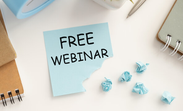 FREE WEBINAR on the tablet pc screen and by businessman hands - online