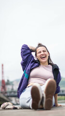 smiling girl sitting in front of the river