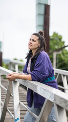smiling girl sitting in front of the river