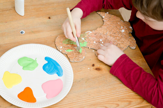 Activities for children. Art lessons at home. Glued Egg shell on Dinosaur shape paper. Reusable materials. Go green.