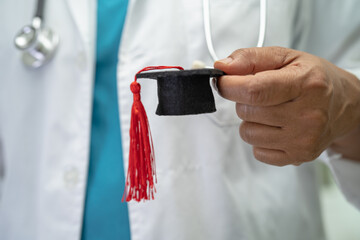 Asian doctor study learn with graduation gap hat in hospital ward, clever bright genius education...