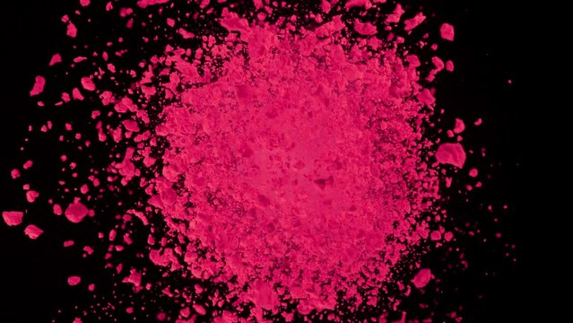 Super Slow Motion Shot of Rotating Pink Powder Expolosion Isolated on Black Background at 1000fps.
