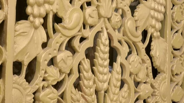 Beautiful elements of oriental buildings with a grape, wheat pattern of golden color that delight with voluminous textures and national style. Closeup. Shot in motion
