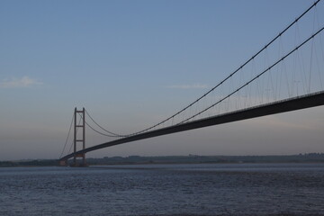 the Humber bridge crossing the river Humber during sunset