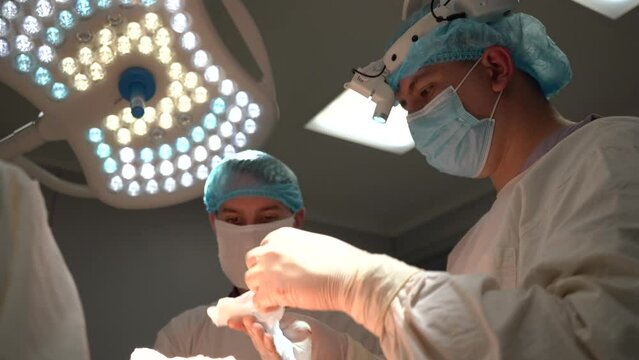 Doctors are doing surgery in modern operating room	