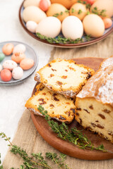 Homemade easter pie with raisins and eggs on plate on a gray concrete background. side view, selective focus.