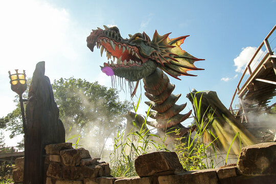 Kaatsheuvel, The Netherlands - June 22, 2014 : Dragon animatronic figure next to the track of the wooden roller-coaster "Joris en de Draak" in Efteling, a theme park in the Netherlands
