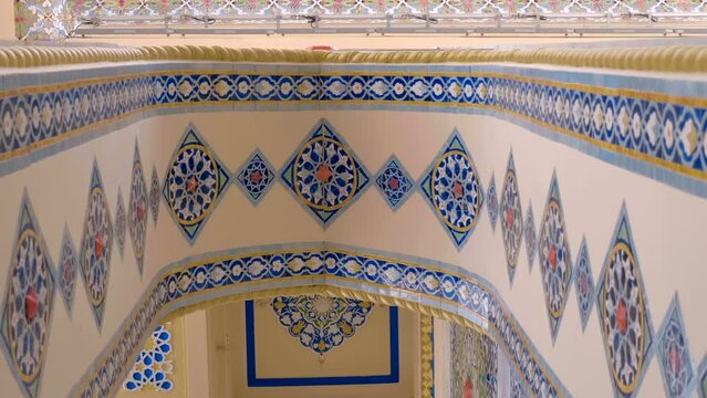 Beautiful colorful elements on cultural famous oriental architectural buildings with floral pattern of ceramic tiles, arches, columns, which stand out with volumetric textures and national style. Shot