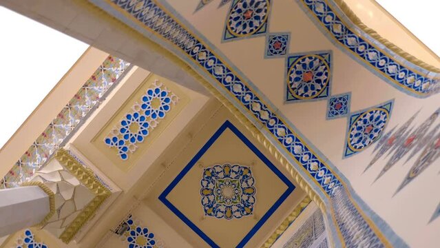Beautiful colorful elements on cultural famous oriental architectural buildings with floral pattern of ceramic tiles, arches, columns, which stand out with volumetric textures and national style. Shot