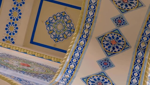 Beautiful colorful elements on cultural famous oriental architectural buildings with floral pattern of ceramic tiles, arches, columns, which stand out with volumetric textures and national style. Shot