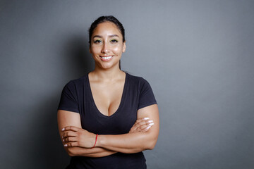 Obraz premium portrait of confident brunette hispanic young woman looking at camera smiling.