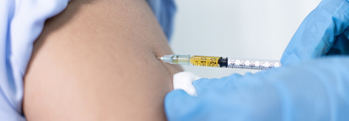 Doctor is vaccinating the patient with antibiotics or virus-resistant antibiotics to prevent the...