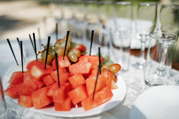 Sliced hors d'oeuvres at takeout catering. Sliced watermelon on a plate.