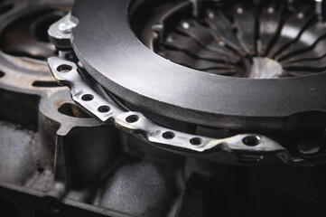 Close-up clutch disc of a car lies on metal parts contrast shot