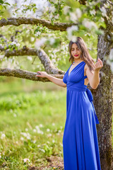 portrait of a woman in a dress in nature on a beautiful spring day