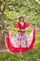 Fototapeta premium portrait of a woman in a dress in nature on a beautiful spring day