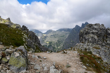 Beautiful sharp rocky peaks of mountain ranges under cloudy sky in the High Tatras, Slovakia