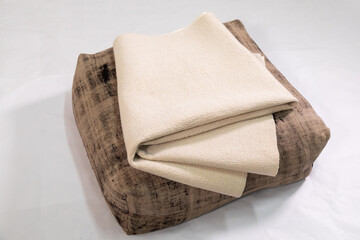 Handmade scratched pillow and white felt blanket on a white background