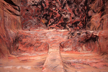 The colorful conformation of rocks inside an excavated tomb, Petra, Jordan