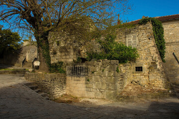 Old derelict residential buildings in the historic medieval hill village of Buzet in Istria,...