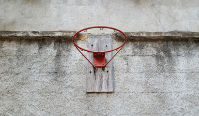 Aro de baloncesto sobre una pared de concreto. © Cristyan