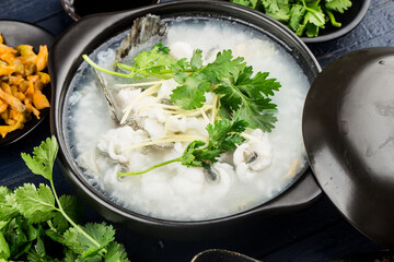 Chinese cuisine; Congee with fish slices in casserole