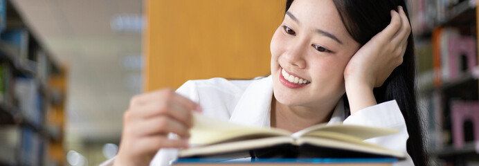 Asian female college students are reading and studying in the library, Learning in the library...
