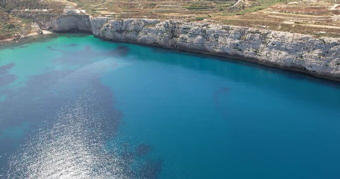 Aerial view of cliffs, stones and sea. spring time. Europe. The camera moves forward. Island of Malta
