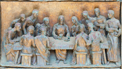 MONOPOLI, ITALY - MARCH 6, 2022: The bronze relief  the Laste Supper on the gate of church Chiesa...