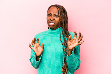 Young african american woman isolated on pink background rejecting someone showing a gesture of...