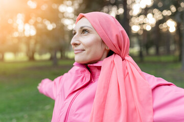 happy female breast cancer survivor looking positively to the sky after overcoming disease. fighter...
