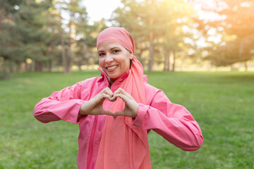 Happy mature bald Caucasian confident woman enjoying life after surviving breast cancer. makes a...