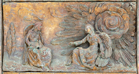 MONOPOLI, ITALY - MARCH 6, 2022: The bronze relief Annunciation on the gate of church Chiesa di...