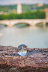 View of the Adige River inside a Lensball from Castelvecchio Bridge in Verona, Veneto, Italy, Europe, World Heritage Site