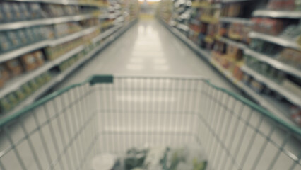 Blurry images of supermarket cart from people POV or point of view angle and shopping in the big...
