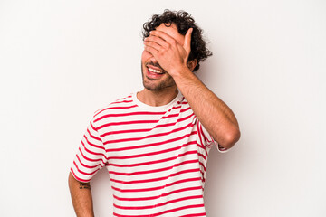 Young caucasian man isolated on white background covers eyes with hands, smiles broadly waiting for a surprise.